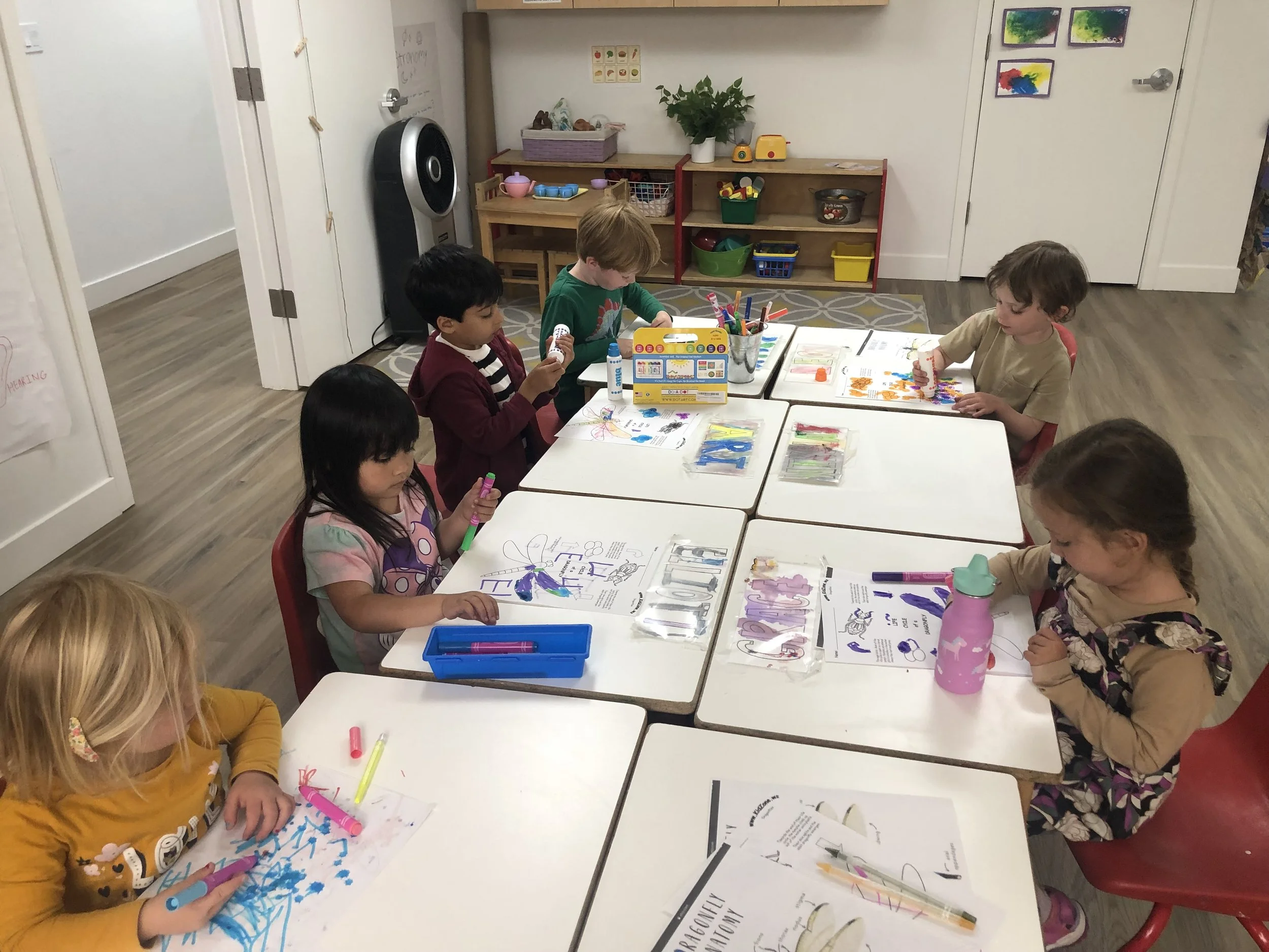 A child exploring sensory and craft materials